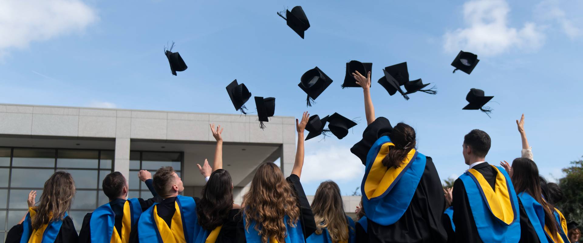 Students throwing mortar boards in air